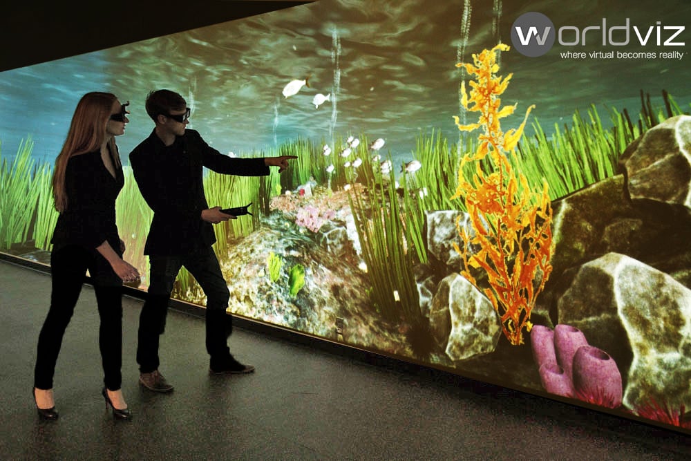 An image of two people looking at a video of a marine floor using augmented reality sets.