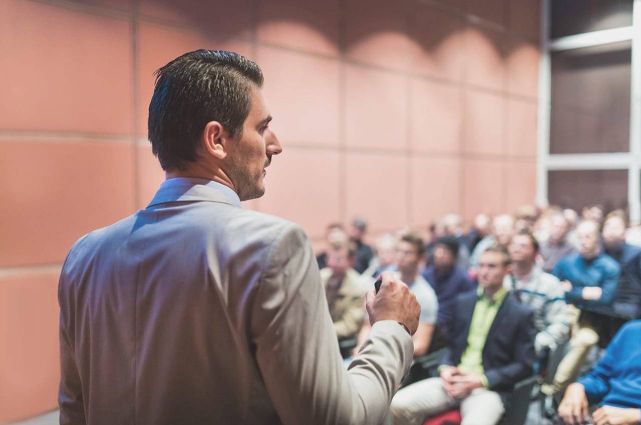 Presenter facing large audience