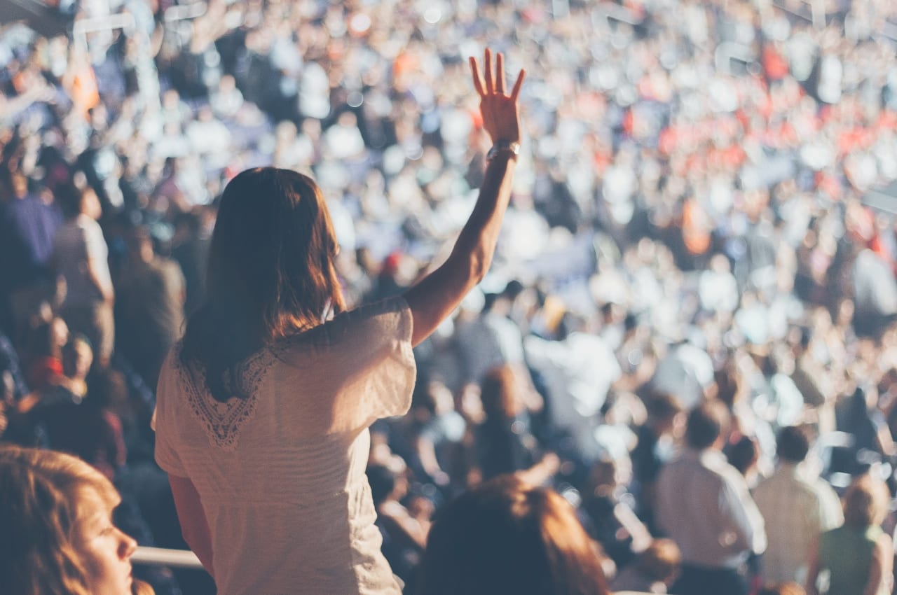 interactive presentation examples Audience member with hand raised