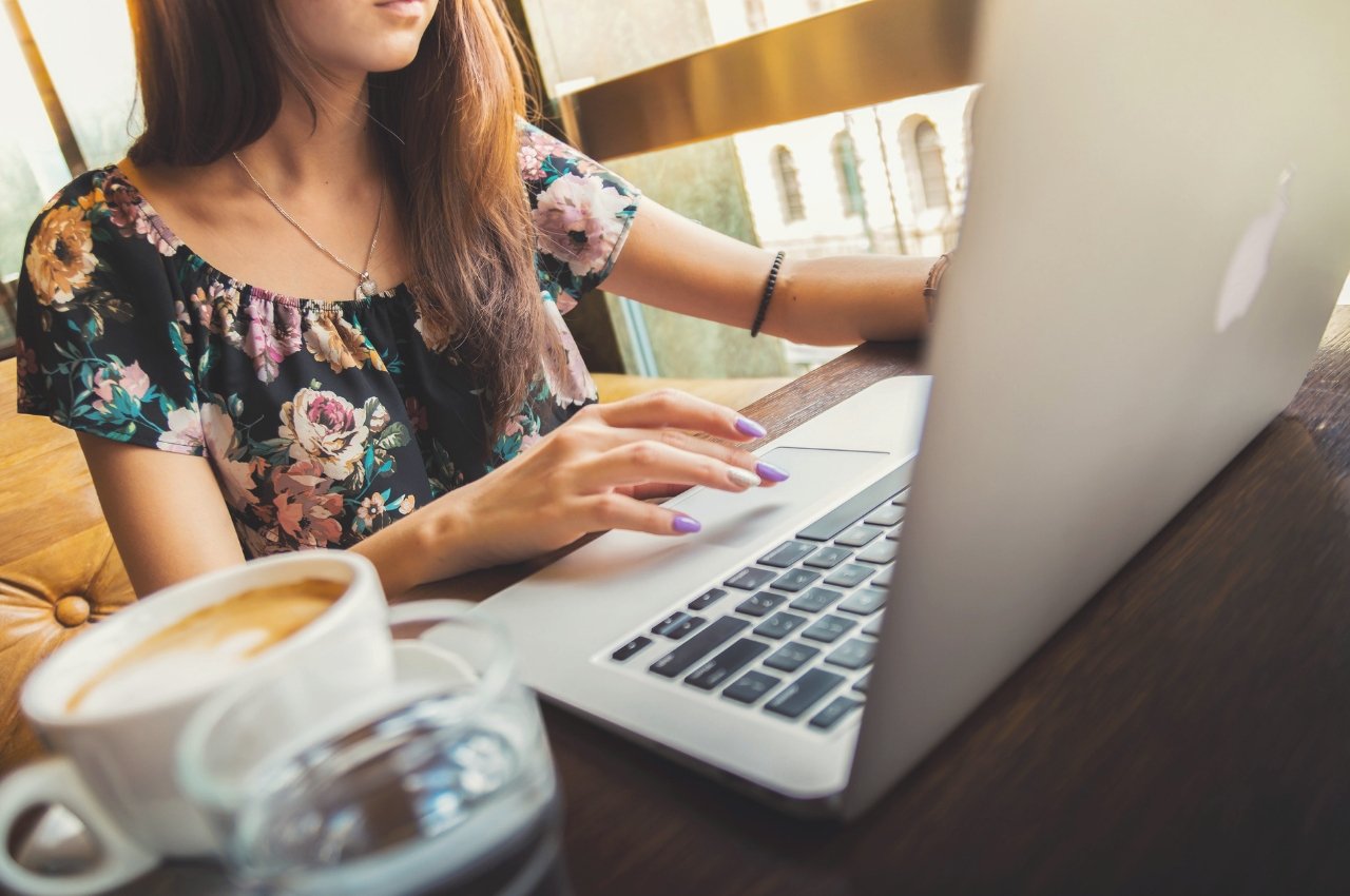 Woman at laptop with coffee