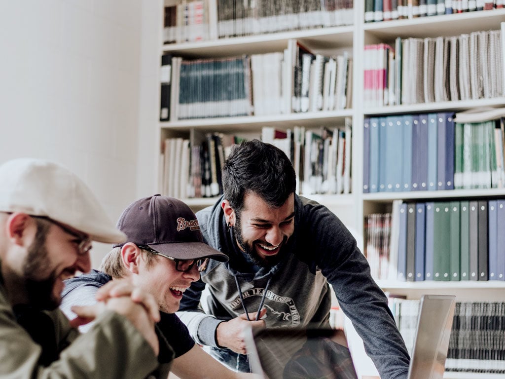 group-of-people-looking-at-a-laptop