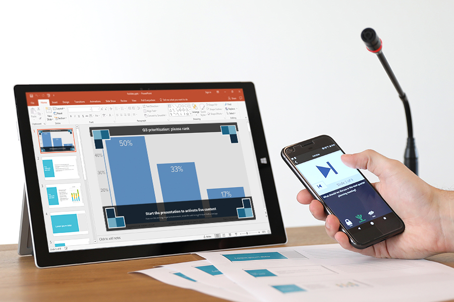 PowerPoint displaying a Poll Everywhere activity on a tablet and iPhone displaying Poll Everywhere remote control mode