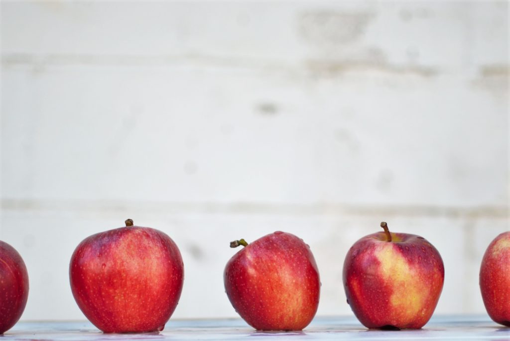 three-apples-on-white-surface
