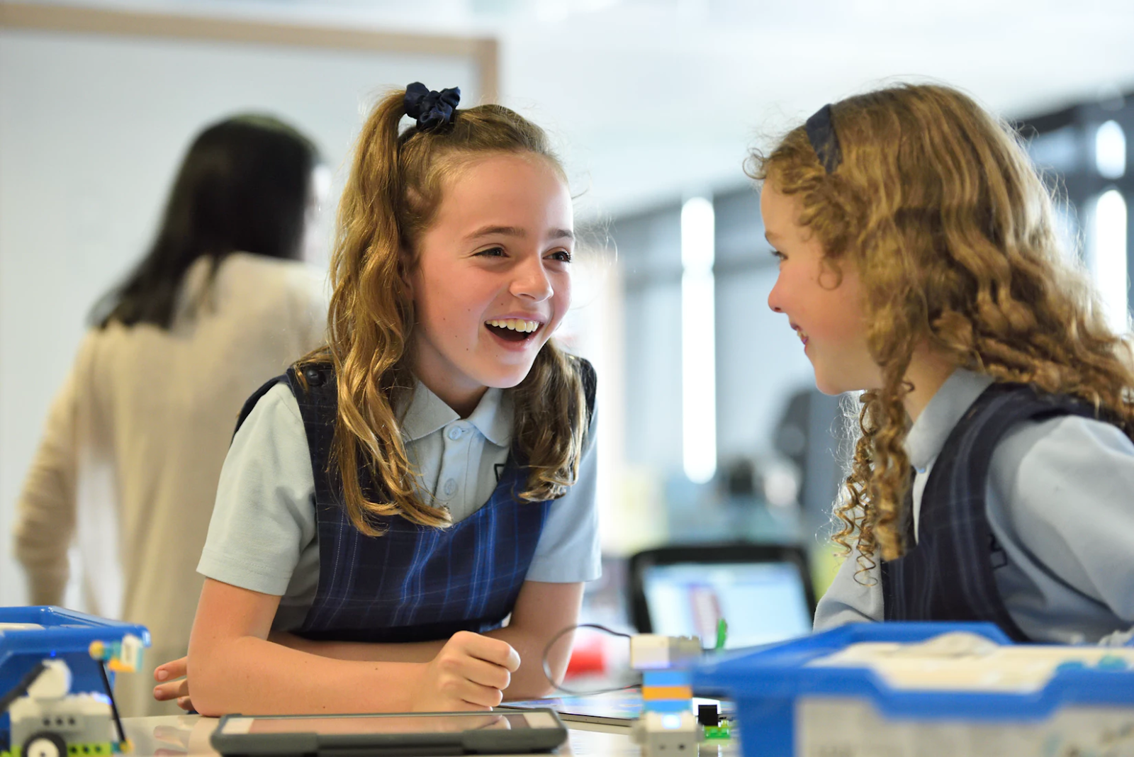 Two students laughing in class.